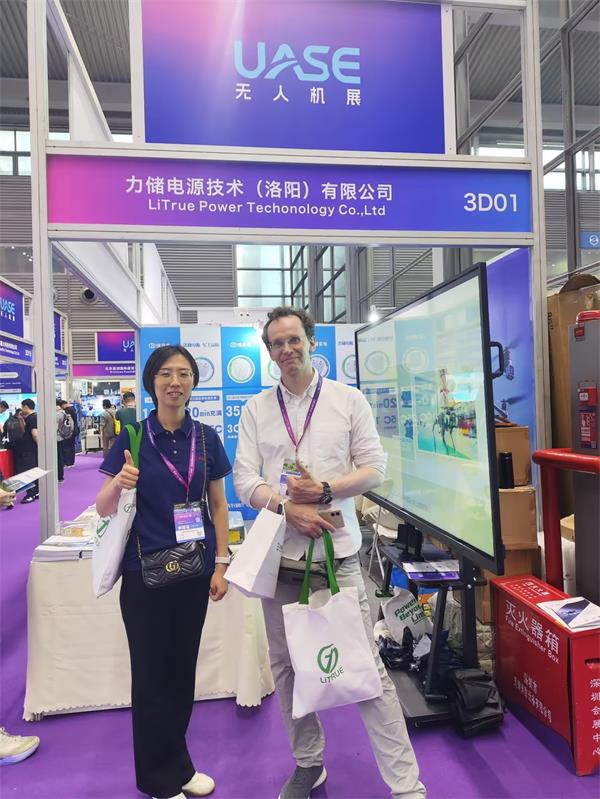 LiTrue technical experts posing with international clients sharing feedback on custom UAV battery cooperation